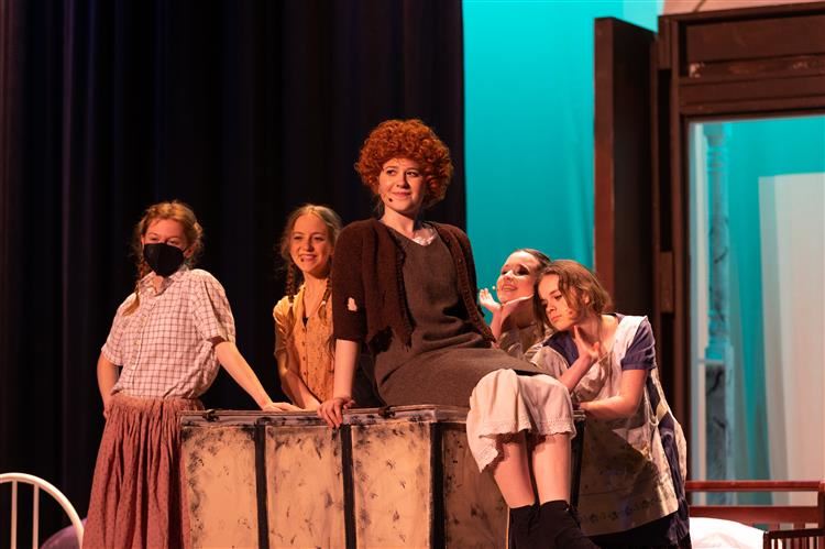 Students on stage performing Annie