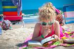 young girl reading on beach